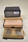 A Stereo slide viewer and two boxes of slides 'vues de Lourdes'