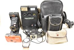 A selection of cameras including Kodak EK160-EF instant camera, Ensign folding camera, Kodak Brownie
