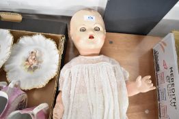 A 20th century composite doll having blue sleeping eyes and christening gown