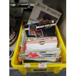 A box of 70's 80's and 90's 45rpm vinyl record singles
