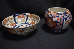 Two pieces of Japanese Imari wares including ovoid vase with decorated panels of Prunus and a footed