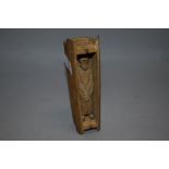 An unusual Japanese wooden carved figure of an official in a coffin