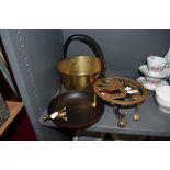 A selection of brass wares including rampant lion trivet, jam pan and sauce pan and a candle
