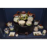 A selection of 20th century Watcombe Torquay pottery motto wares including large teapot, small