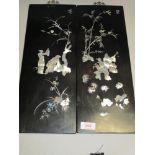 A pair of 20th century Japanese Ebonised wood panels with mother of pearl inlay design