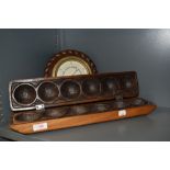 A carved wood ball holder or mould having carved decoration along with an Edwardian barometer