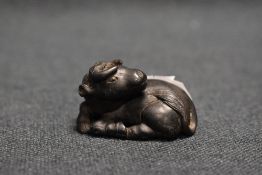 An early 20th century Japanese carved wood Netsuke sculpture of an Ox