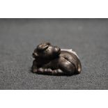 An early 20th century Japanese carved wood Netsuke sculpture of an Ox