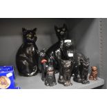 A selection of 20th century ceramic cat figures including black tabby cats with green and yellow