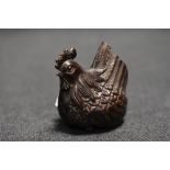 An early 20th century Japanese carved wood Netsuke of a Chicken or Hen