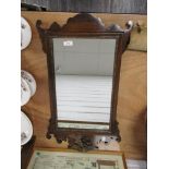 A 20th century Chippendale revival style mirror having shaped frame work with carved eagle