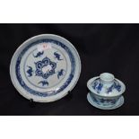 An early 19th century Japanese hard paste plate in blue and white design with a modern tea bowl