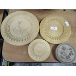 Four wooden butter moulds in traditional farmhouse pattern