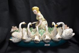 A German porcelain Monteith centre piece decorated with cherub and leafs, with a ceramic table
