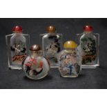 Five vintage Oriental glass snuff bottles with designs of storks, cockerels and similar.