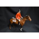 A Beswick figure of Huntsman on brown horse having minor chip to cap