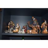 A 20th century ceramic nativity scene with three wise kings and a baby Jesus