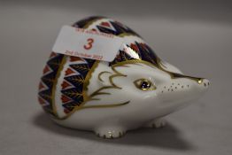 A Royal Crown Derby Hedgehog paperweight having silver coloured stopper.