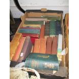 A box of vintage library books including Dickens and Kafka Oscar Wilde and Longfellows