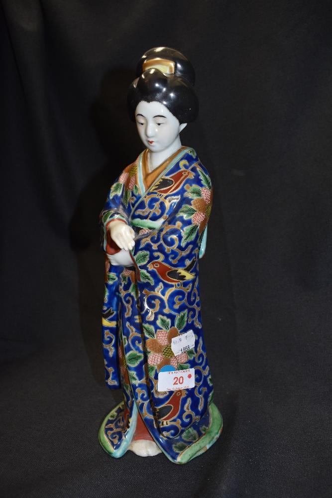 A figurine of a traditionally dressed Oriental lady.