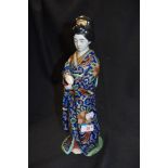 A figurine of a traditionally dressed Oriental lady.