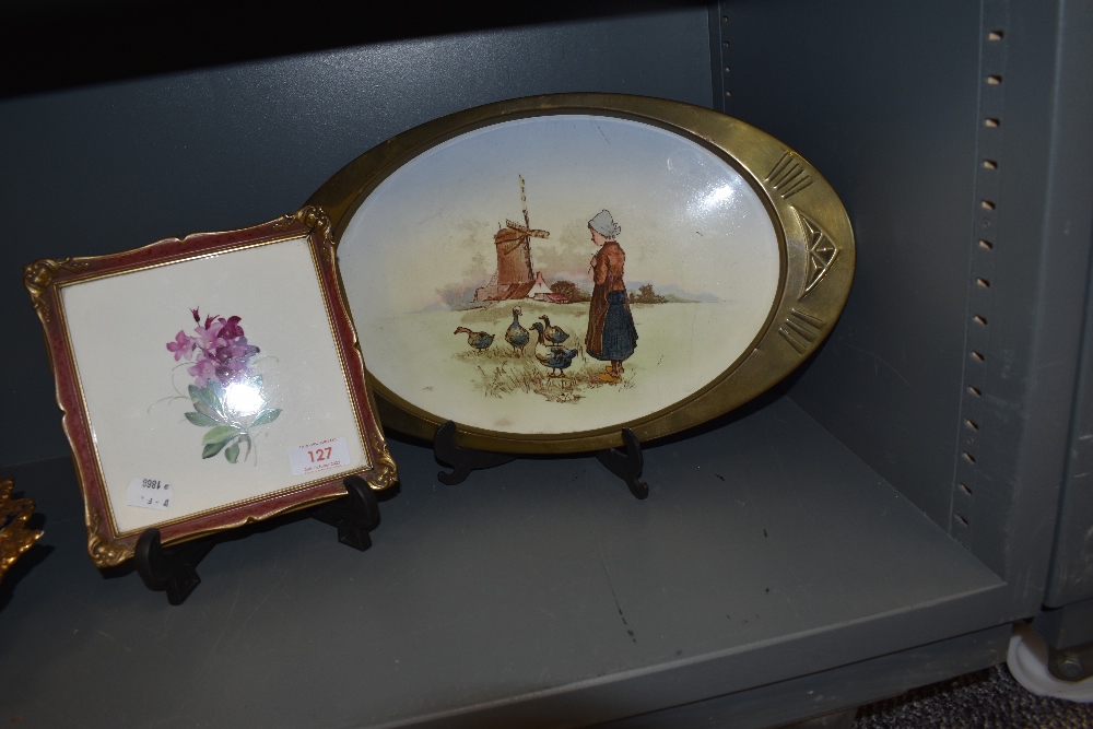 An early 20th century tray with oval brass surround and printed tile depicting a Dutch girl