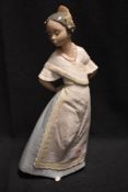 A 20th century Nao figurine of a maiden in dress