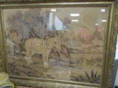 A machine woven tapestry style embroidery of horses at river side in an ornate gilt and gesso frame