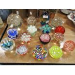 A selection of modern art glass paper weights in various designs including dump style, Millefiori