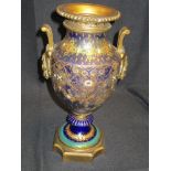 A Victorian mantel urn having ceramic cobalt and gilt decorated body with bronze gilt decorations