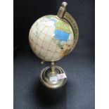 A desk top globe of small proportions.