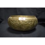 A 19th century Indian brass bowl decorated with foliage