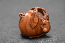 An early 20th century Japanese carved wood Netsuke of two mice eating a Pumpkin