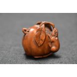 An early 20th century Japanese carved wood Netsuke of two mice eating a Pumpkin