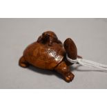 An early 20th century Japanese carved wood Netsuke of a mother tortoise with a baby climbing upon