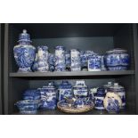 Two shelves of early 20th century Masons, Ringtons and Pratts blue and white ware ceramics