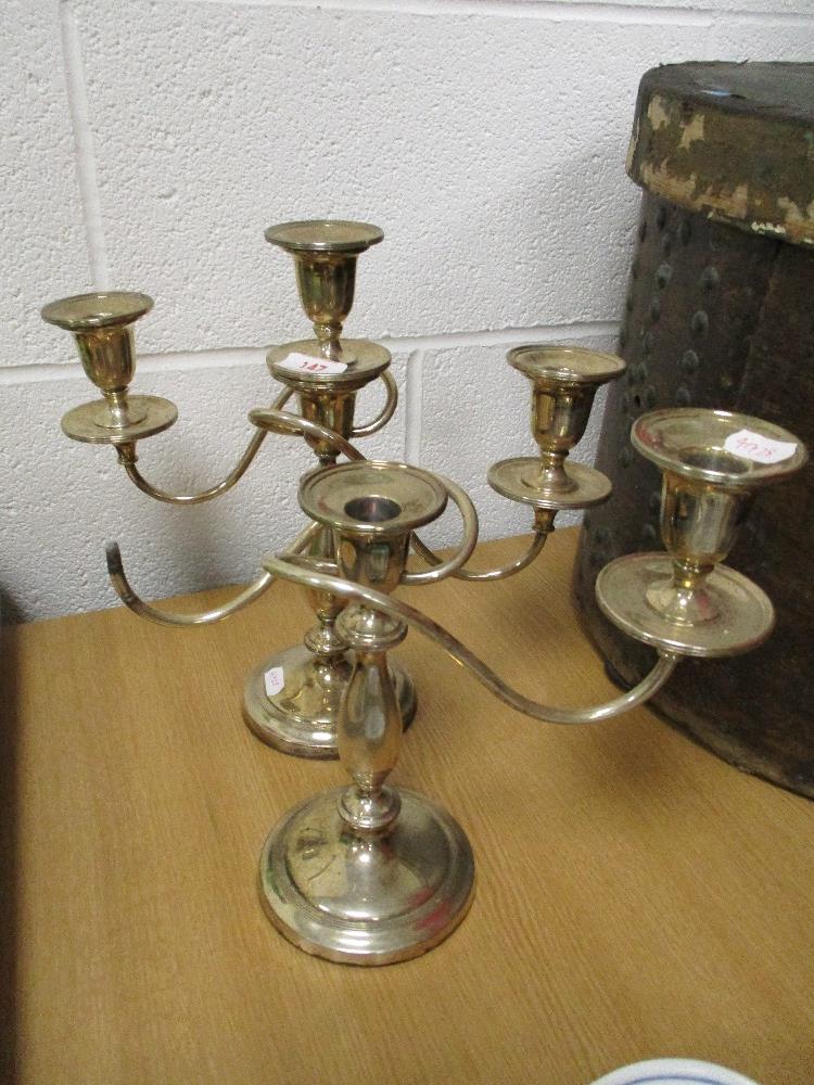 A traditional candelabra candlestick with a similar stick AF