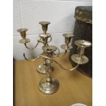 A traditional candelabra candlestick with a similar stick AF