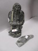 A mid century Wolf sculpture of an Inuit or Eskimo with similar seal figure