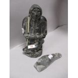 A mid century Wolf sculpture of an Inuit or Eskimo with similar seal figure