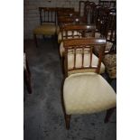 A set of six Edwardian mahogany dining chairs, the slightly bowed top rails with inlaid banding over