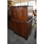 A reproduction mahogany bow fronted drinks cabinet with inset glass top. 125CM.