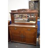 An Art Nouveau mahogany mirror back sideboard, with stipple carved scrolling foliate decoration.