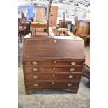 A George III mahogany bureau, the fall front with herring bone banding, over four long cockbeaded