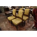 A set of four Victorian carved mahogany dining chairs, each upholstered in foliate patterned and