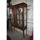 An Edwardian inlaid mahogany display cabinet, having ribbon and swag inlaid frieze, over pendant