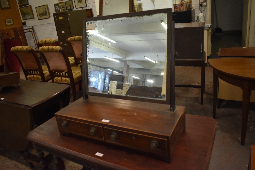 A 19th century crossbanded mahogany swing dressing mirror. the base with two drawers, spotting to