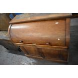 A Victorian Mahogany cylinder bureau, the curved front lifting to reveal an arrangement of drawers