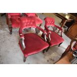 A pair of Edwardian stained mahogany tub form armchairs, upholstered in maroon material, the backs