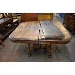 Victorian morgani extending dining table, of rounded square form with carved edge detail over the